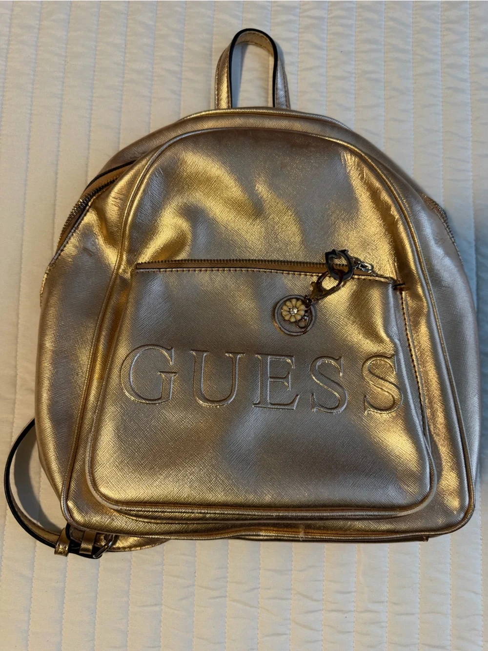 GUESS Metallic Gold Logo Backpack with Flower Charm